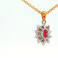 Oval shaped ruby and round brilliant cut diamond cluster style pendant Gardiner Brothers