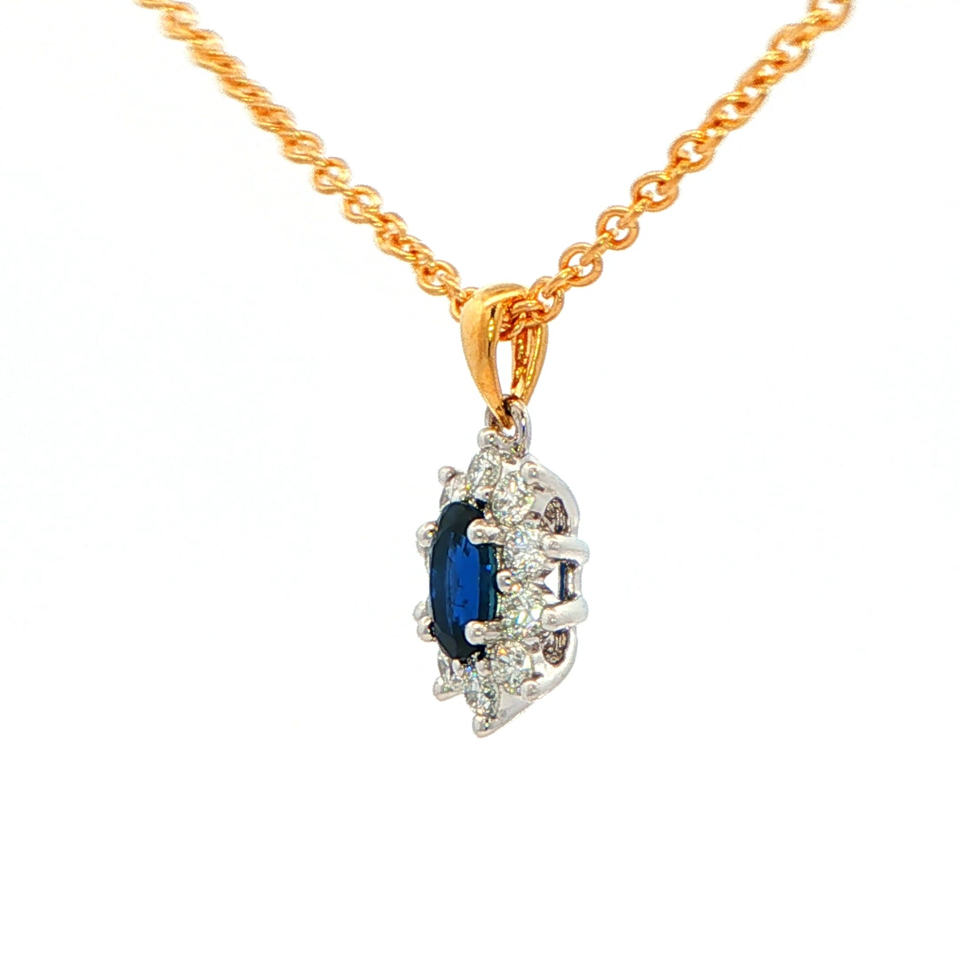 Oval shaped sapphire and round brilliant cut diamond cluster style pendant Gardiner Brothers
