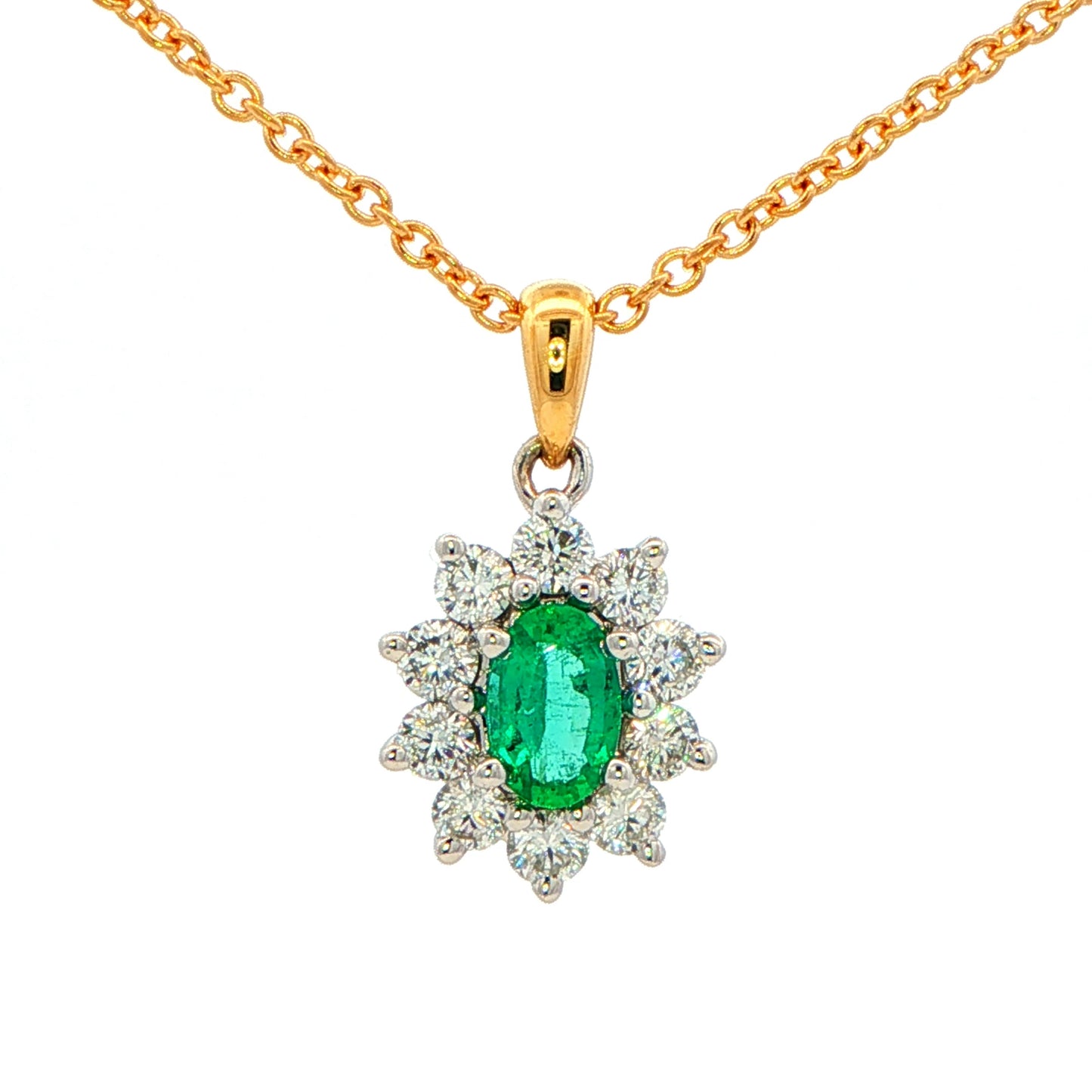 Oval shaped emerald and round brilliant cut diamond cluster style pendant Gardiner Brothers