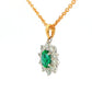 Oval shaped emerald and round brilliant cut diamond cluster style pendant Gardiner Brothers