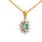 Oval shaped emerald and round brilliant cut diamond cluster style pendant Gardiner Brothers
