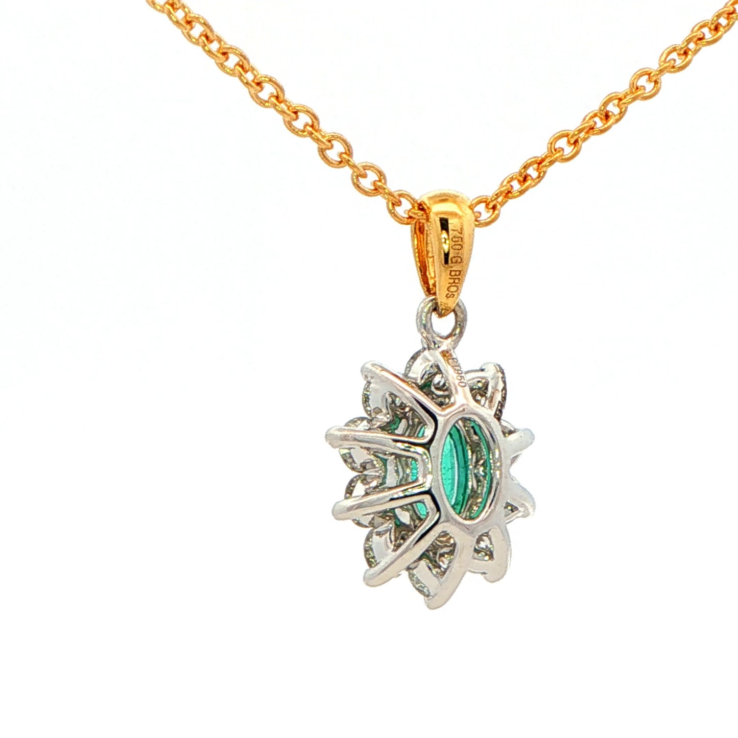 Oval shaped emerald and round brilliant cut diamond cluster style pendant Gardiner Brothers