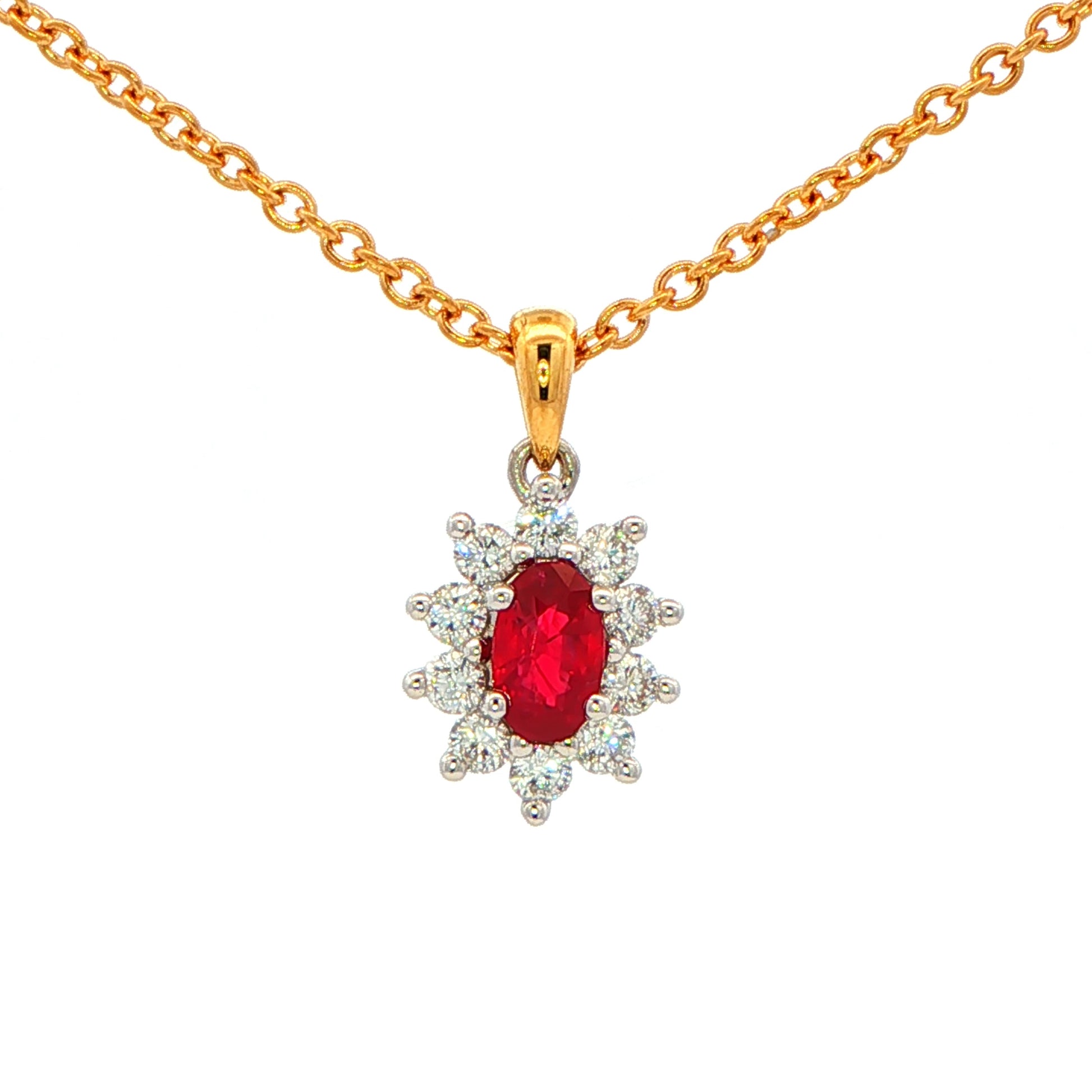 Oval shaped ruby and round brilliant cut diamond cluster style pendant Gardiner Brothers