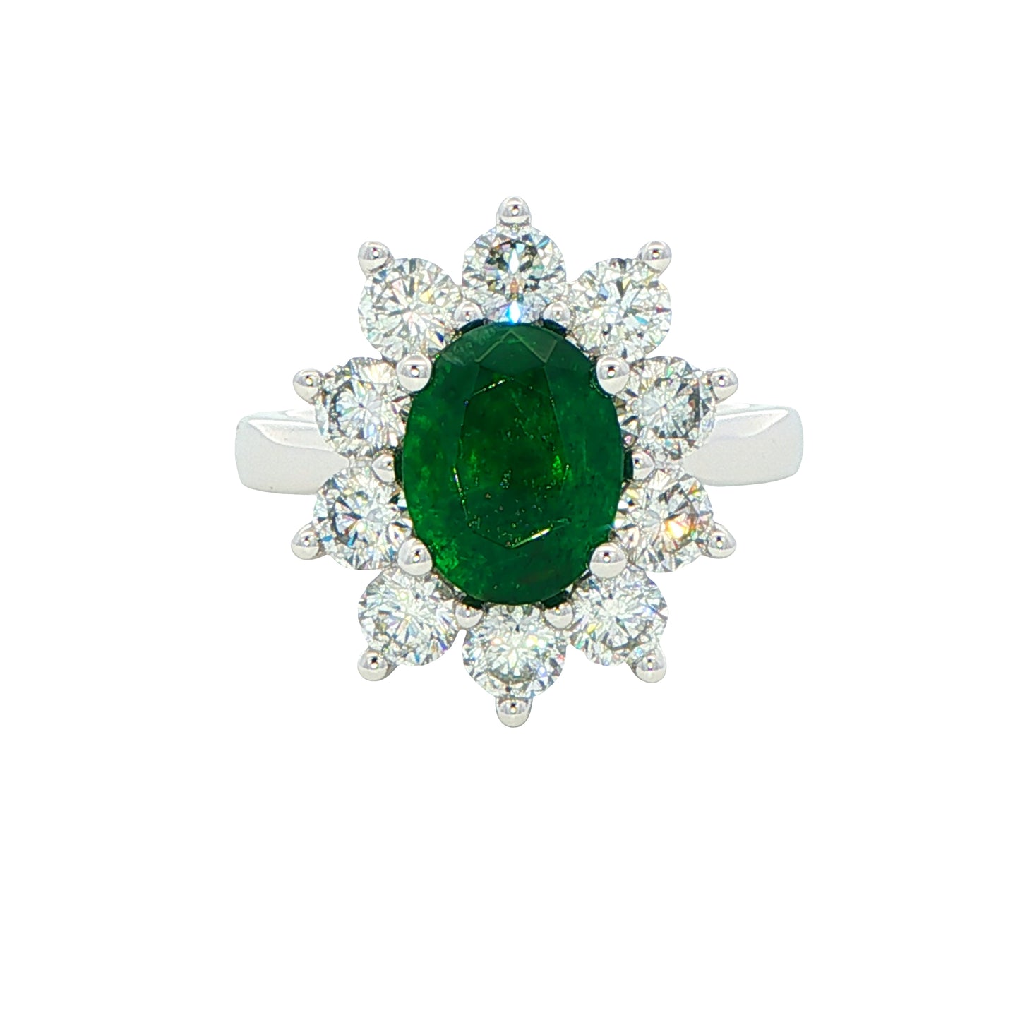 Oval shaped emerald and round brilliant cut diamond cluster style ring Gardiner Brothers