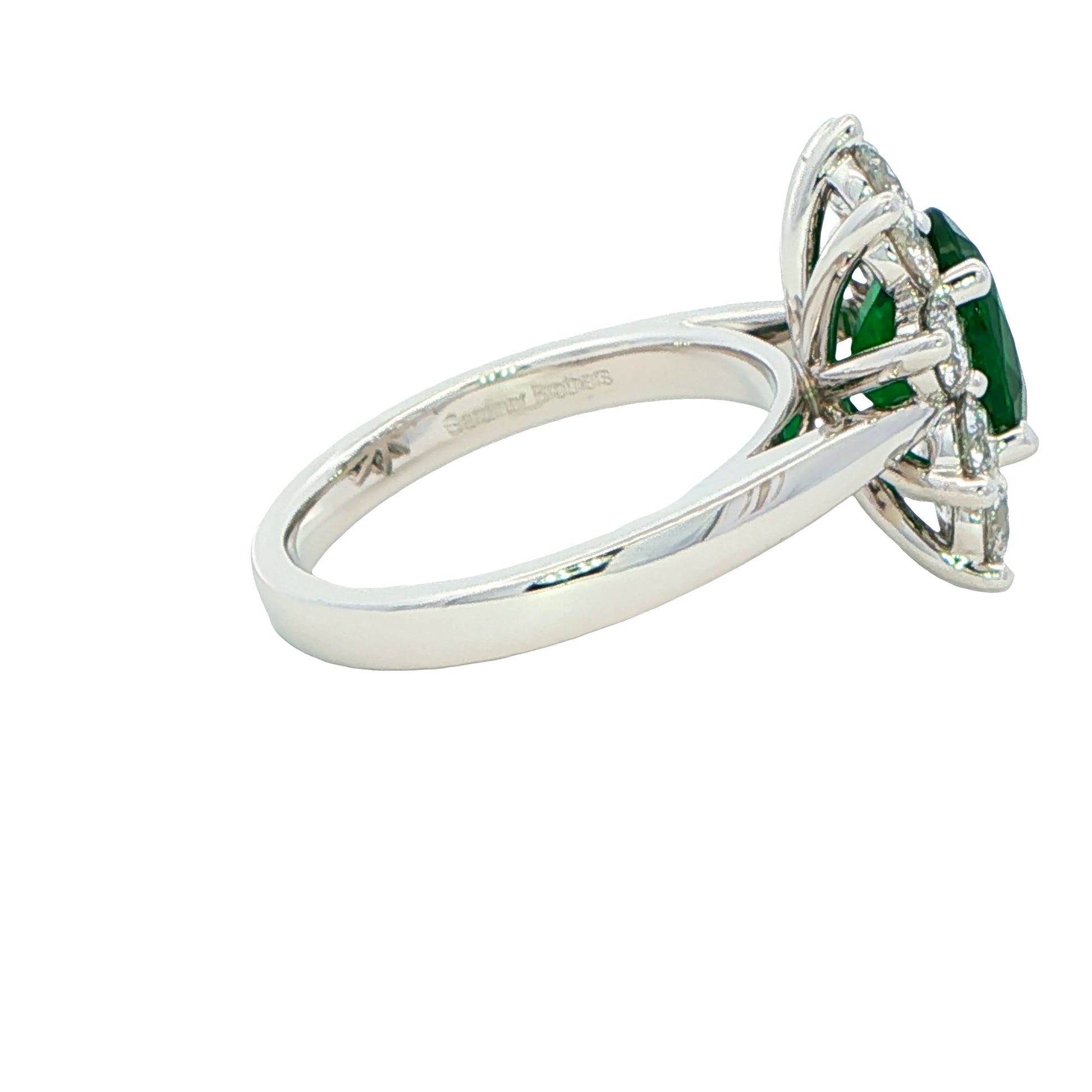 Oval shaped emerald and round brilliant cut diamond cluster style ring Gardiner Brothers