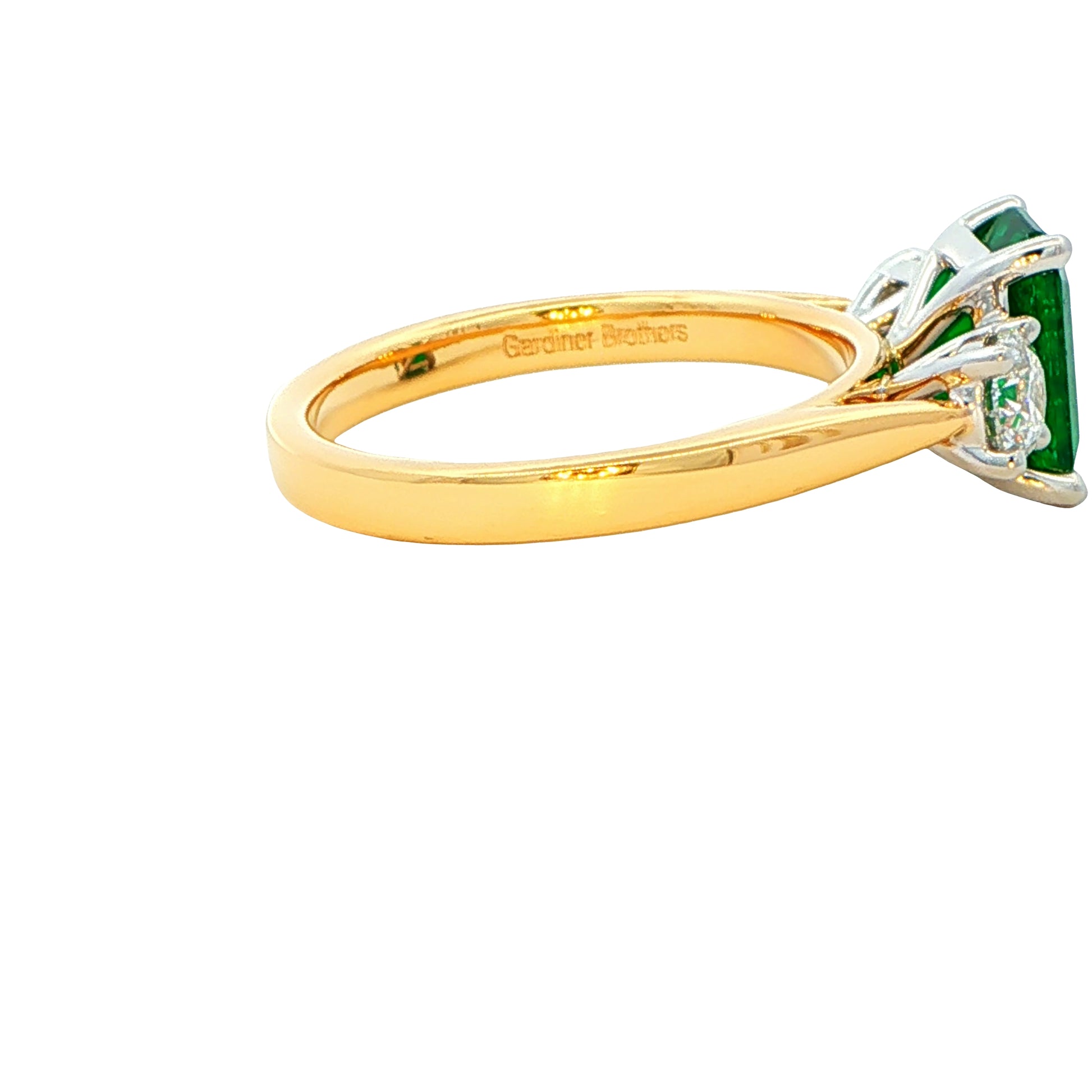 Octagonal emerald and round brilliant cut diamond 3 stone ring Gardiner Brothers