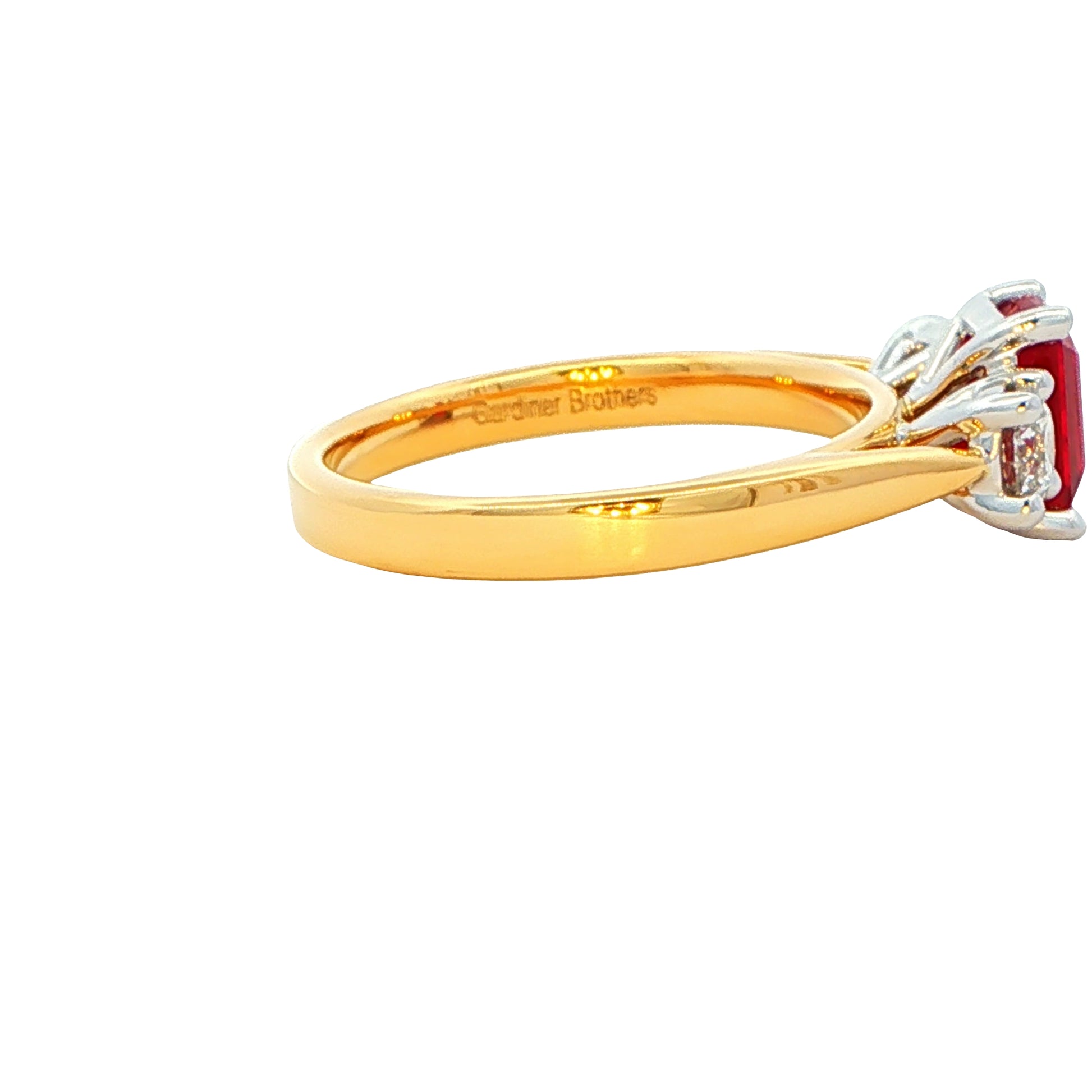 Octagonal Ruby and round brilliant cut diamond 3 stone ring Gardiner Brothers
