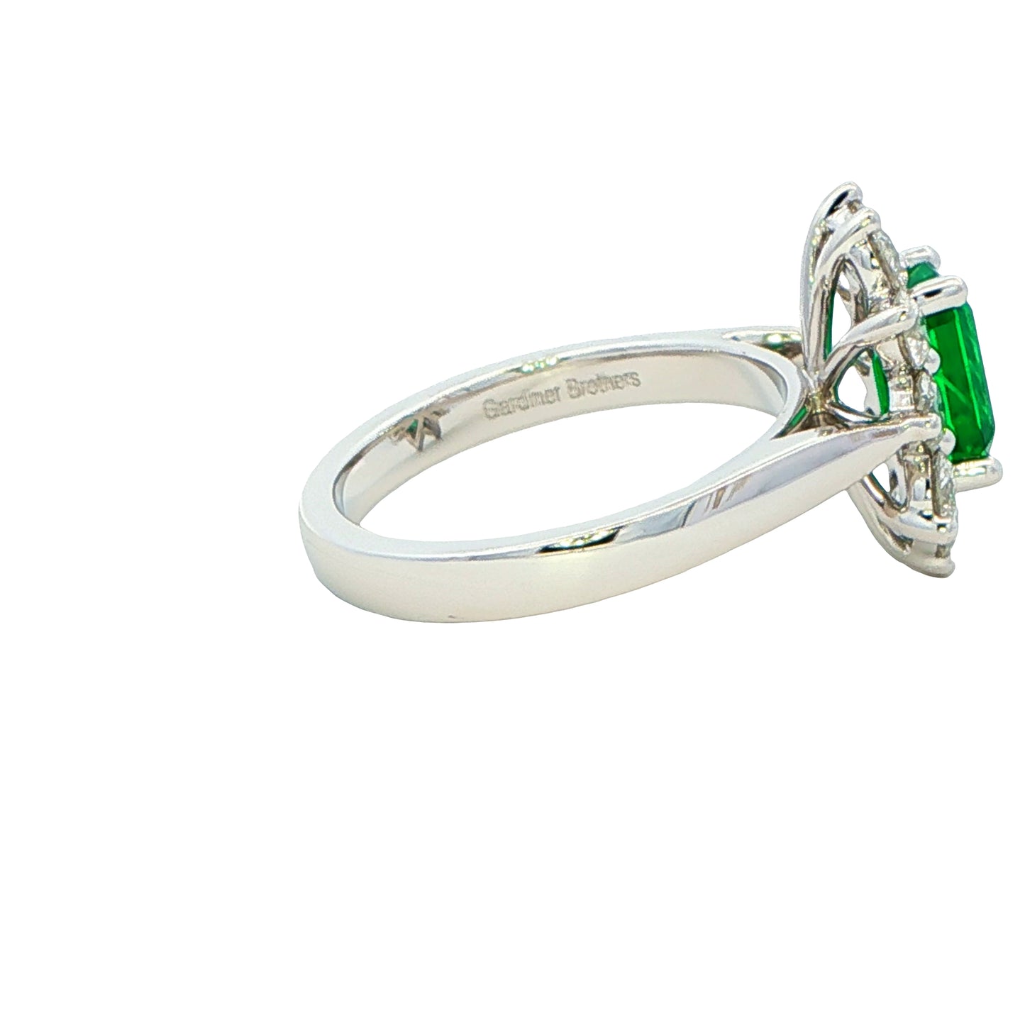 Octagonal shaped emerald and round brilliant cut diamond cluster style ring Gardiner Brothers