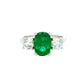 Cushion shaped emerald and round brilliant cut diamond 3 stone ring Gardiner Brothers