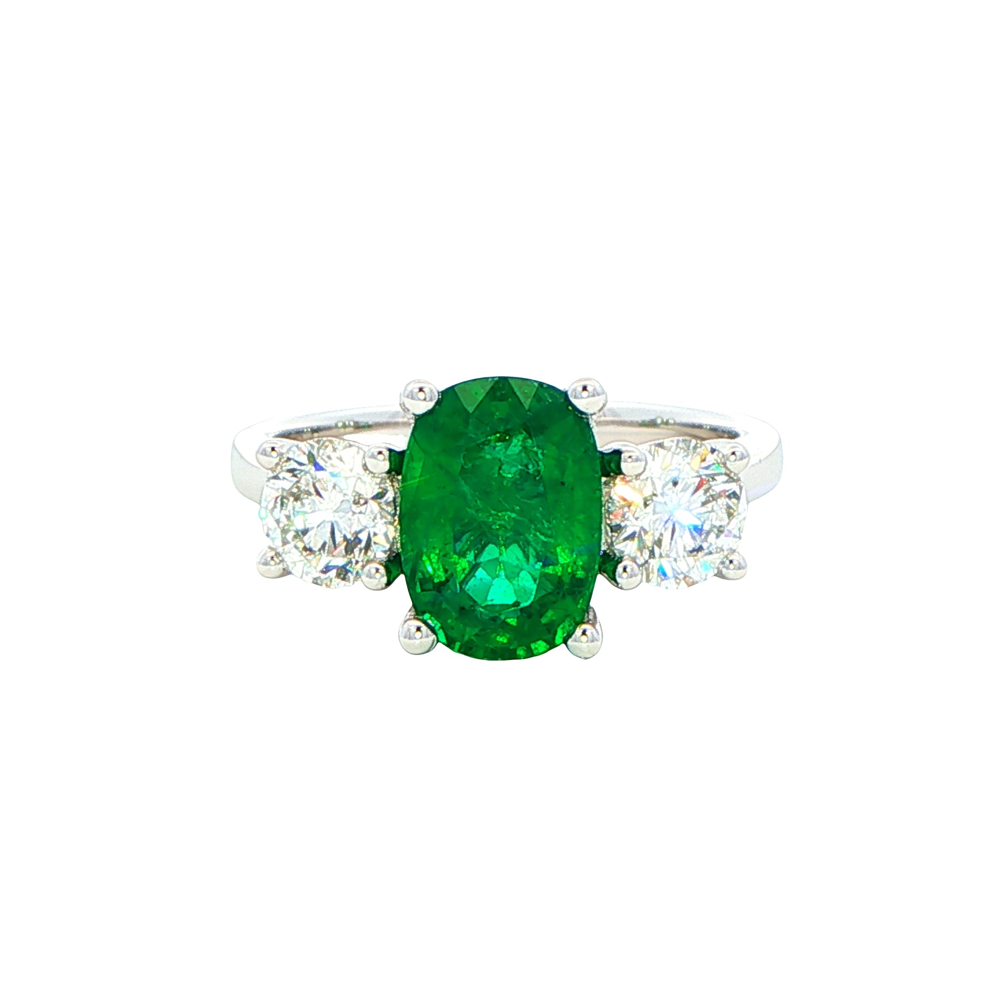 Cushion shaped emerald and round brilliant cut diamond 3 stone ring Gardiner Brothers