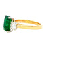 Octagonal shaped emerald and round brilliant cut diamond 3 stone ring Gardiner Brothers