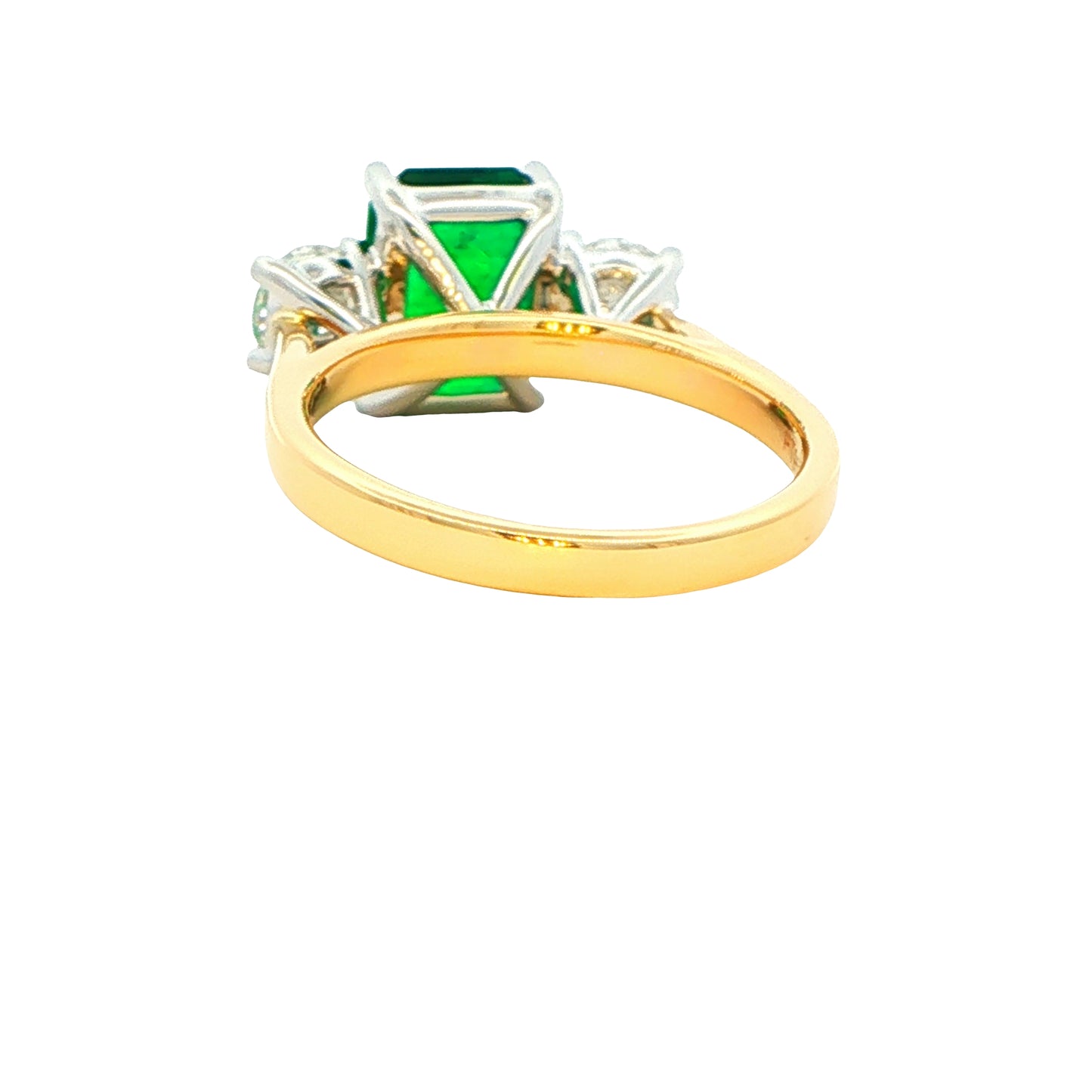 Octagonal shaped emerald and round brilliant cut diamond 3 stone ring Gardiner Brothers