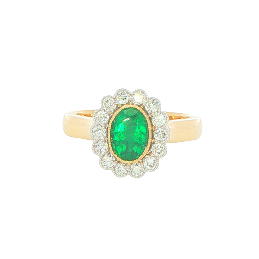Oval emerald and round brilliant cut diamond vintage style cluster ring