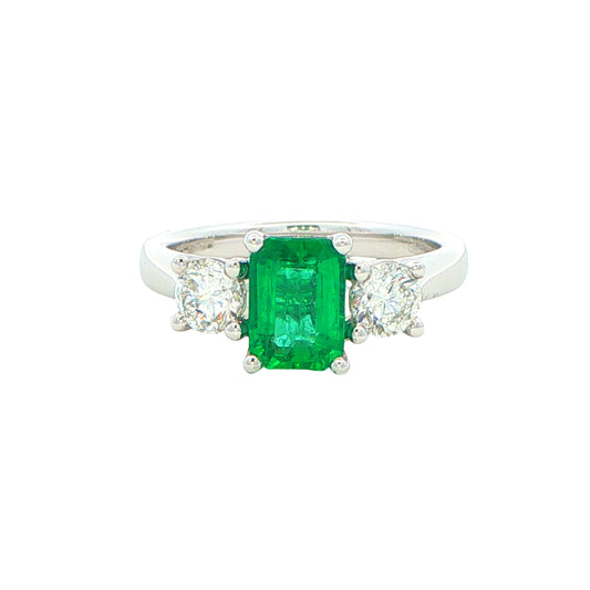 Octagonal shaped emerald and round brilliant cut diamond 3 stone ring Gardiner Brothers