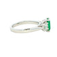 Octagonal shaped emerald and round brilliant cut diamond 3 stone ring Gardiner Brothers