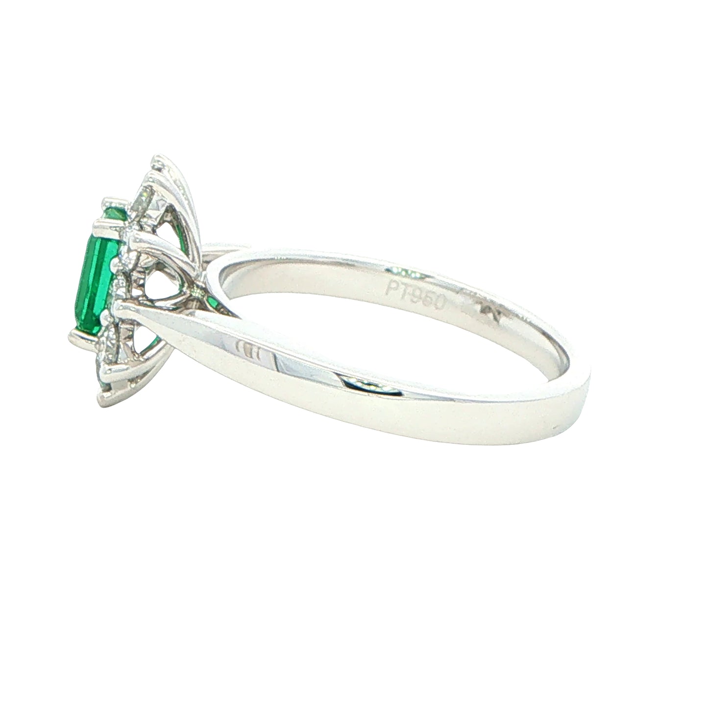 Octagonal shaped emerald and round brilliant cut diamond cluster style ring
