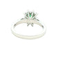 Octagonal shaped emerald and round brilliant cut diamond cluster style ring