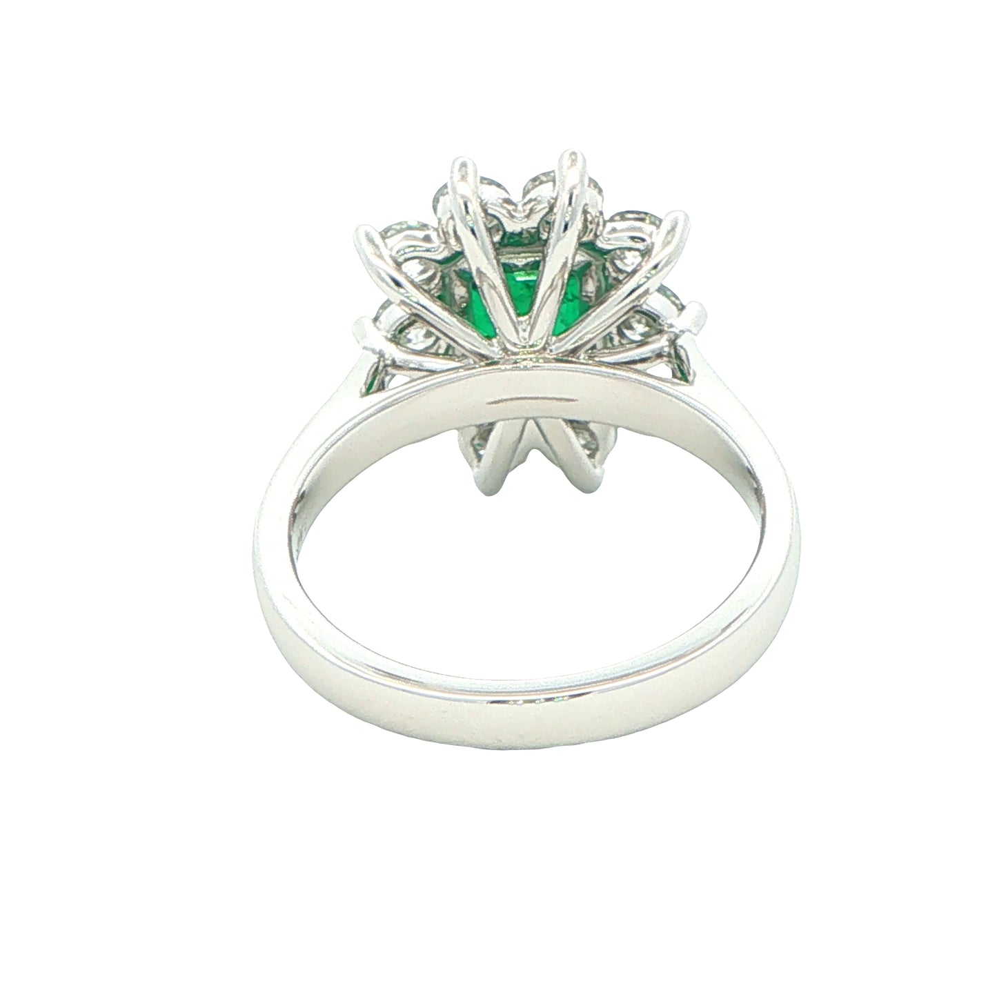 Octagonal shaped emerald and round brilliant cut diamond cluster style ring