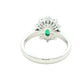 Emerald and round brilliant cut diamond cluster style ring