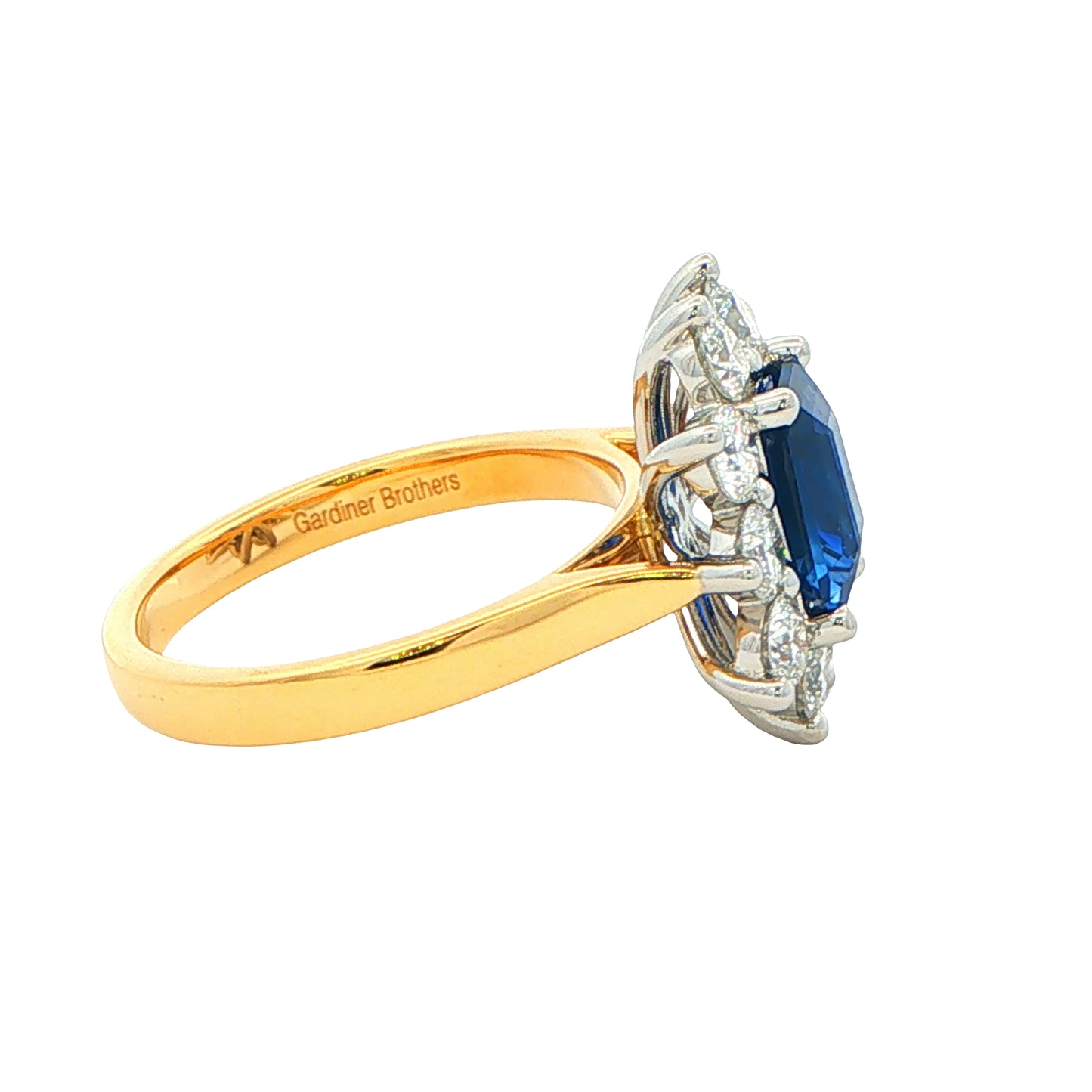 Octagonal Sapphire and round Brilliant Cut Diamond Cluster Style Ring