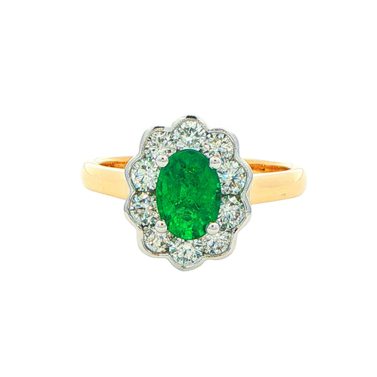 Oval Emerald and Round Brilliant Cut Diamond Cluster Ring