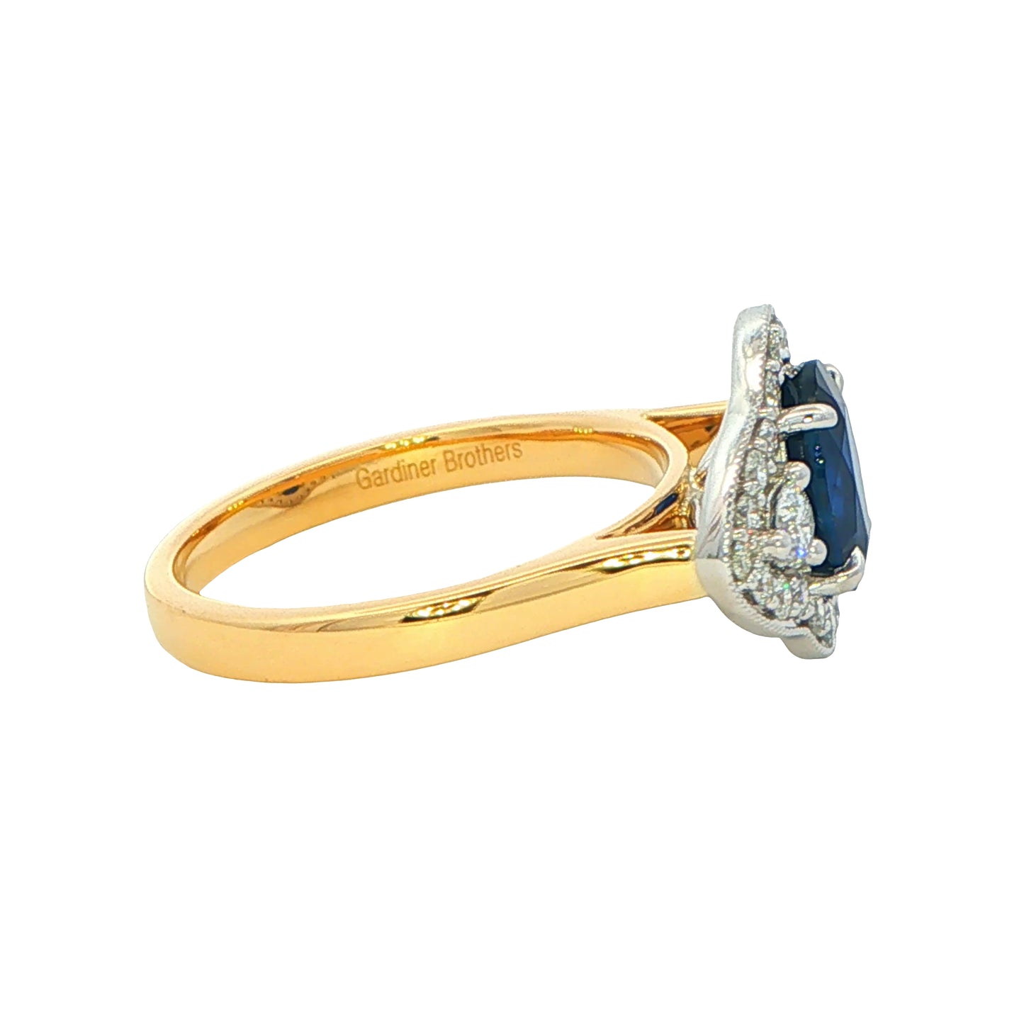 Oval Sapphire and round brilliant cut diamond fancy halo style ring