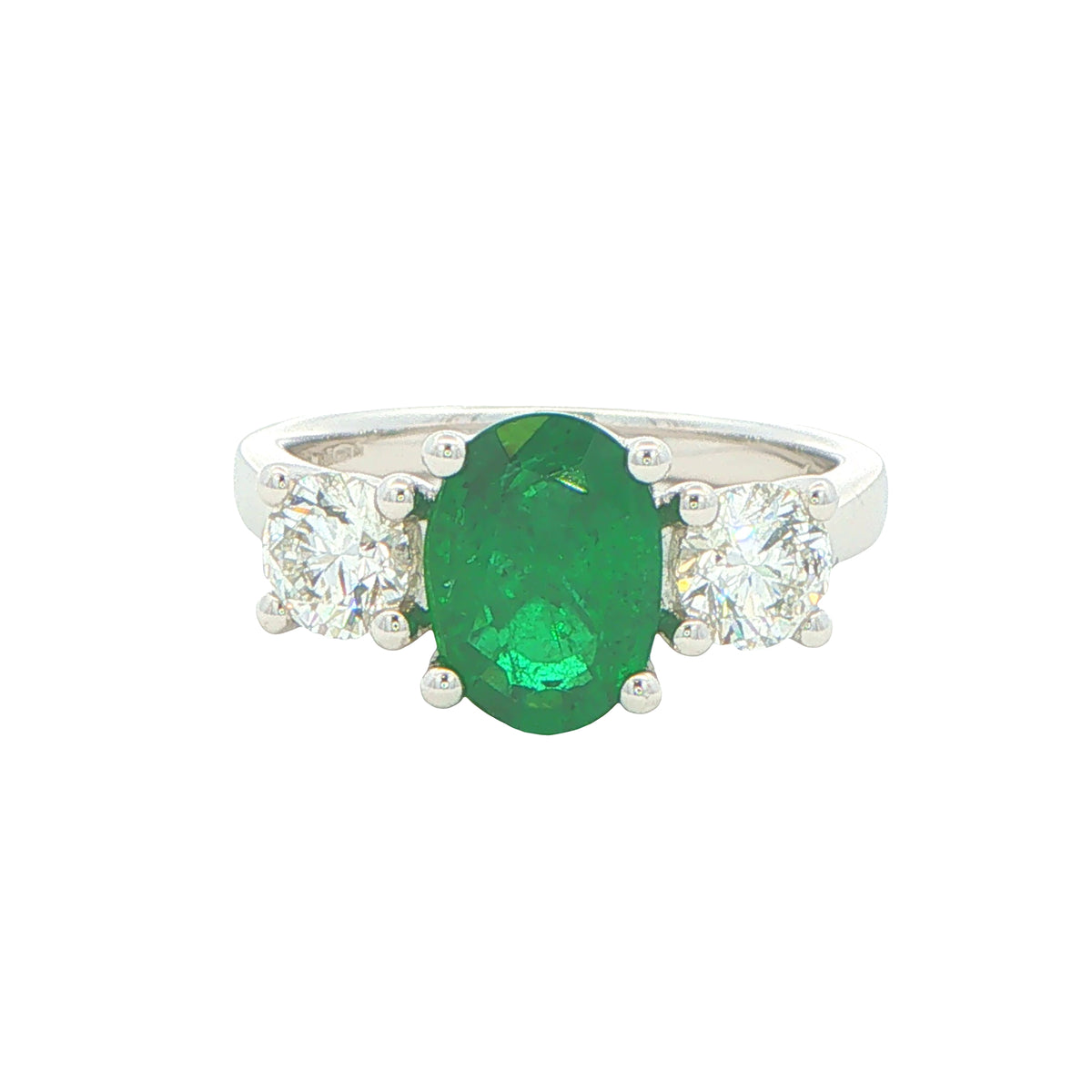 Oval Emerald and round brilliant cut diamond 3 stone ring