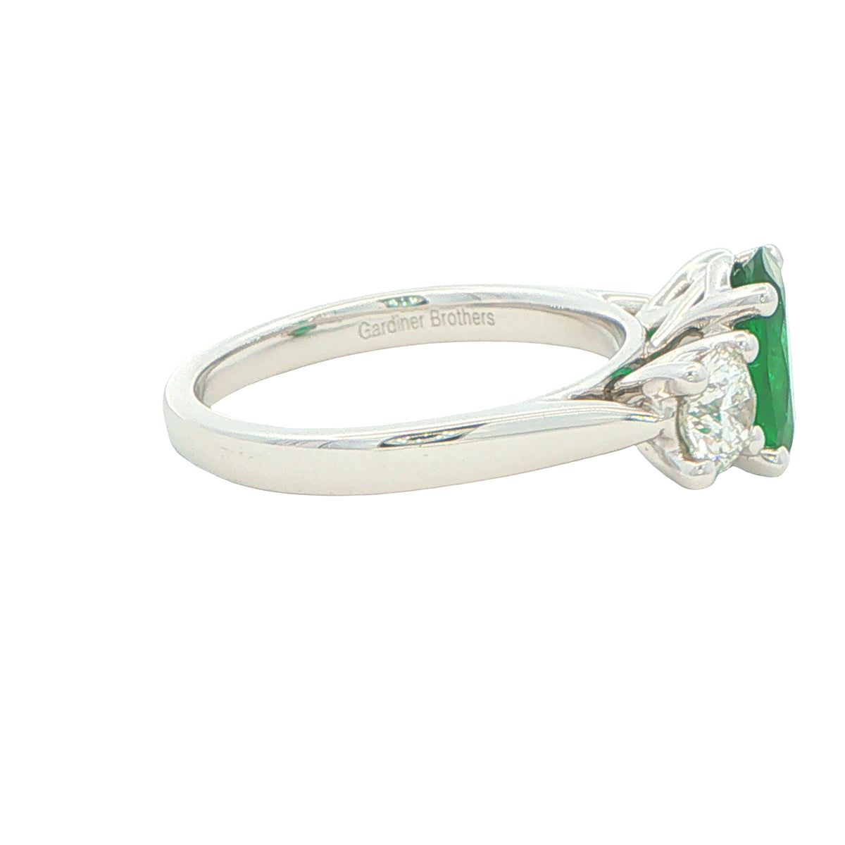 Oval Emerald and round brilliant cut diamond 3 stone ring