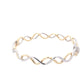 Yellow and White Gold Wavy Style Cross Over Bangle  Gardiner Brothers   