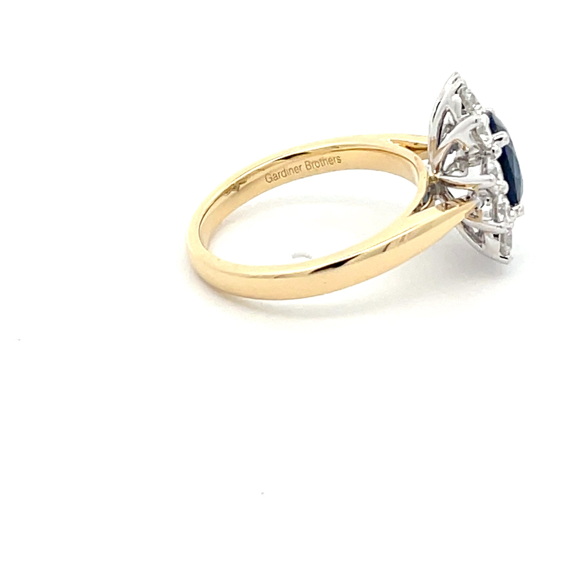 SAPPHIRE AND ROUND BRILLIANT CUT DIAMOND CLUSTER STYLE RING  Gardiner Brothers   