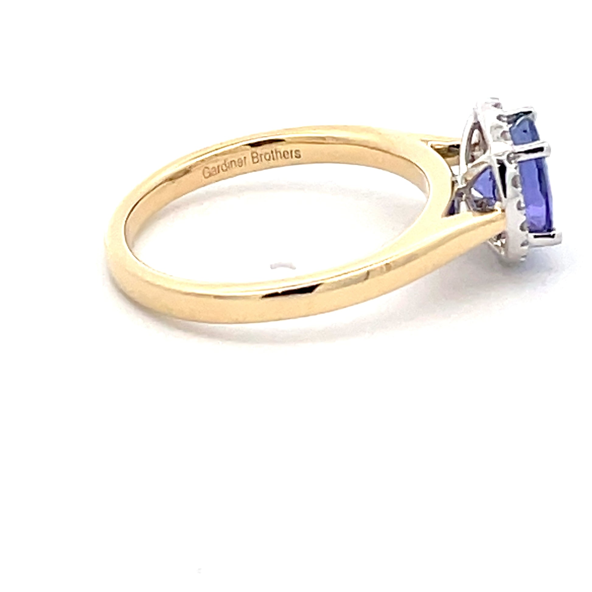 Tanzanite and round brilliant cut diamond halo ring  Gardiner Brothers   