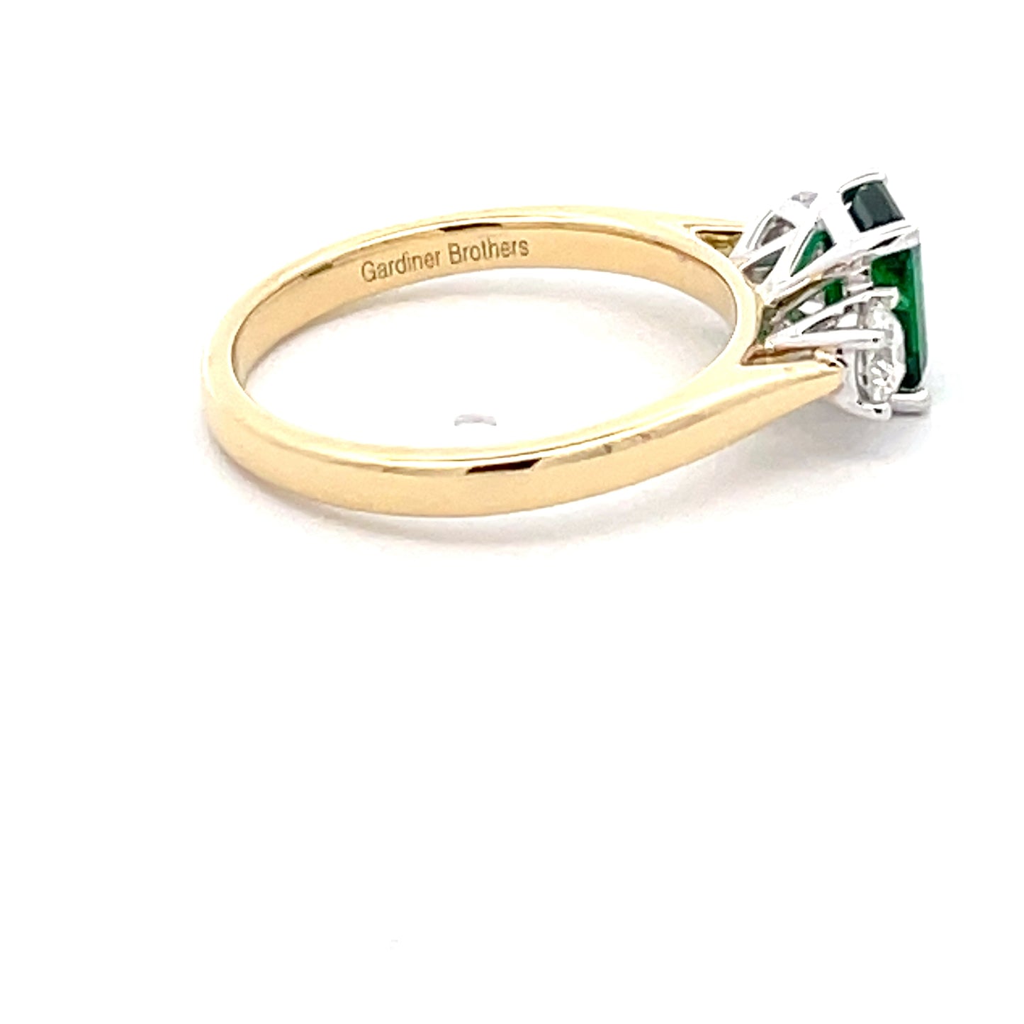 Octagonal Emerald and round brilliant cut diamond 3 stone ring  Gardiner Brothers   